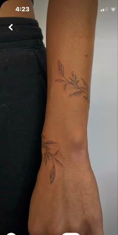 a woman's foot with a tattoo on her left arm and the bottom half of her leg