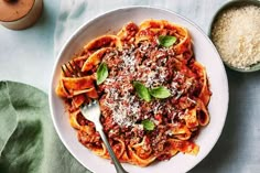 a white bowl filled with pasta and sauce