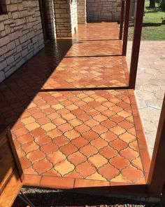 an orange tiled walkway in front of a brick building