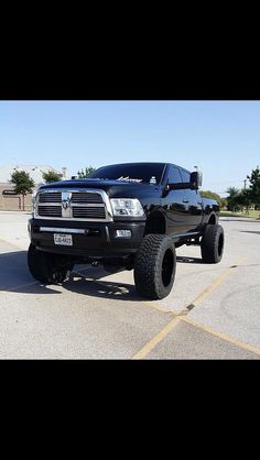 a large black truck parked in a parking lot