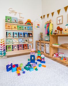 a child's room with toys and bookshelves on the floor in front of it