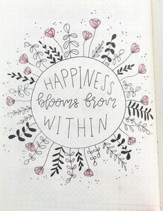 a notebook with the words happiness blooms from within on it and flowers in the middle