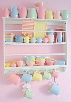 the shelves are filled with colorful dishes and cups