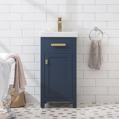 a bathroom with white tiles and blue cabinet