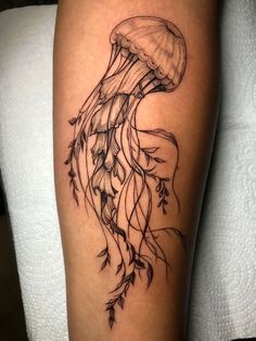 a black and white tattoo of a jellyfish