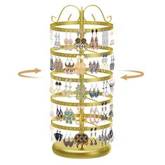 a gold jewelry rack with earrings hanging from it's sides and an arrow pointing to the top