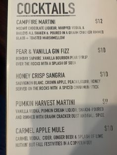 the menu for cocktails is displayed on a table