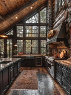 a kitchen with wood floors and large windows in the ceiling, along with an area rug on the floor