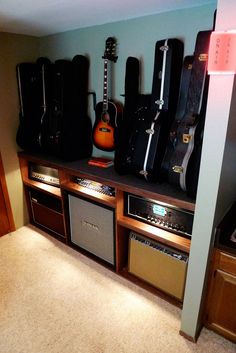 guitars and amps are lined up on the shelf