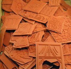 a pile of clay tiles sitting on top of each other