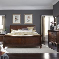 a bedroom scene complete with a bed, dresser and two lamps on the wall - to - ceiling windows