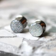 pair of silver and white glittered stud earrings