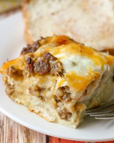 a slice of breakfast casserole on a white plate with a fork in it