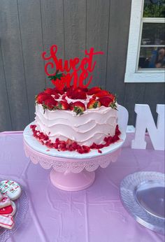 a cake with strawberries on top sitting on a table