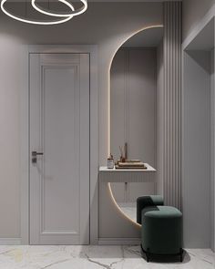 a modern bathroom with marble flooring and white walls, along with an oval mirror on the wall