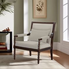 a chair sitting in front of a window next to a potted plant and bookshelf