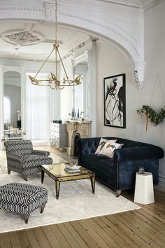 a living room filled with furniture and a chandelier