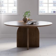 a wooden table with two vases on it and a book in front of the table