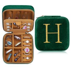 an open green case filled with lots of jewelry