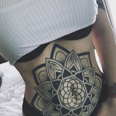 a woman with a tattoo on her stomach