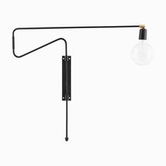 a black wall lamp with a light bulb attached to the back of it and a long arm