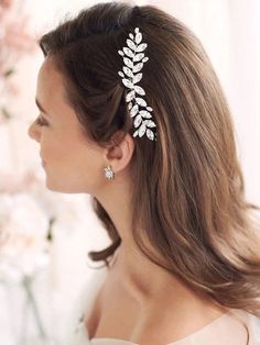 a woman wearing a hair comb with leaves on it