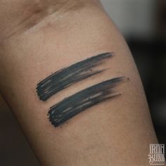 two black ink strokes on the arm