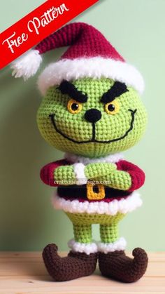 a crocheted grin face doll wearing a santa hat