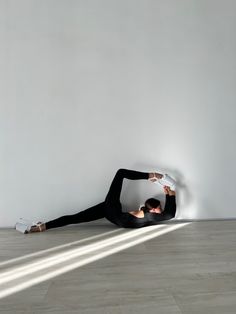 a man laying on the floor with his hands behind his head and arms stretched out