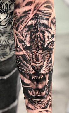 a man with a tiger tattoo on his arm