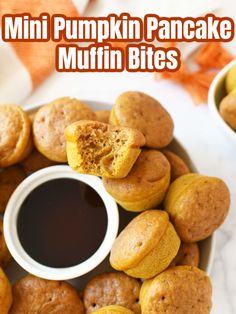 some muffins are on a plate with dipping sauce