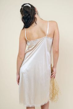 Feminine and romantic cottage core inspired light cream silk nightgown-slip with a delicate lace-pattern at bottom and top. Modern one-piece pullover design with spaghetti straps and V-neckline; the luxurious silk nightdress-slip is over-knee length which makes it elegant and a great piece. Slips on overhead for wear Great for under your dresses Adjustable straps Care: hand wash cold / line dry Fit Notes & Other Info Model Olivia: Height: 5'9" Bust: 33" Waist: 26" Hip: 35" Buying & Wearing Antiq White Silk Nightgown, Silk Night Dress, Silk Nightdress, Backless Slip Dress, Womens Sleepwear, Satin Nightie, Silk Nightgown, Vintage Slip, Bodice Top