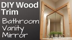 a bathroom vanity mirror with the words diy wood trim