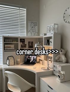 the corner desk has a computer on it and is next to a window with blinds