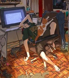 a woman laying on the floor in front of a computer desk with a cat sitting on top of it