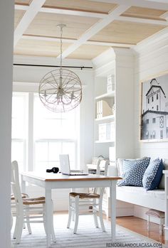 a dining room table with chairs and a laptop on it