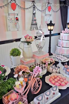 a table topped with lots of cakes and desserts