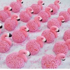 there are many pink flamingos made out of rice krispy kreme balls