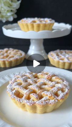 an image of some desserts on a white plate with flowers in the back ground