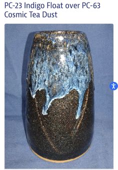 a black and blue vase sitting on top of a table