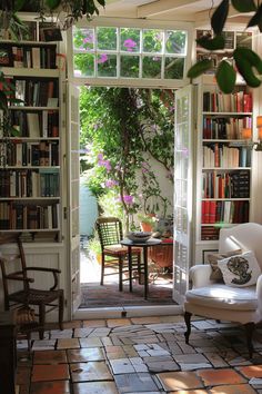 a living room filled with furniture and lots of books