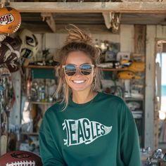 Eagles football pennant shirt. Perfect to cheer on your favorite team.  Graphic is printed in white ink.  T-shirt sizes 2T-Adult 3XL. Long Sleeve sizes Youth XS-Adult 3XL.  See description for shirt brands. *WILL SHIP ON OR AFTER 12/12. PRODUCT DETAILS Comfort Colors Unisex Heavyweight T-Shirt (C1717) Color: Light Green 6.1 oz, 100% Ringspun Cotton Comfort Colors Unisex Heavyweight Long Sleeve (C6014) Color: Light Green 6.1 oz, 100% Ringspun Cotton Comfort Colors Unisex Crewneck Sweatshirt (1566 Pennant Sweatshirt, Eagles Outfit, Football Pennant, Philadelphia Eagles Colors, Philly Football, Philadelphia Eagles Crewneck, Philadelphia Eagles Shirts, Eagles Shirt, Vintage Philadelphia Eagles Sweatshirt