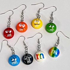 "Nem Nems" is a super cute pair of mix and match M & M earrings. They measure approx 1.2 round and are set into silver ear wires and have coordinating findings. Choose your favorite color or mix & match them for your own unique look. Please choose from the following:  - black - blue - green - orange - rainbow M - red - stripe - yellow Your new earrings will come perfectly packaged in a navy blue drawstring organza bag - perfect for gift giving or to keep your new earrings safe.  Please feel free Chocolate Covered Candy, Mix Match Earrings, Orange Rainbow, Candy Earrings, Color Chocolate, Red Stripe, Organza Bags, Chocolate Covered, Gift Giving