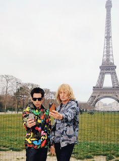 two people standing in front of the eiffel tower