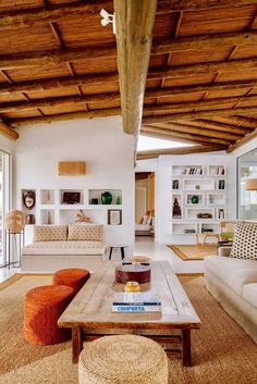 the living room is clean and ready for us to use it's natural wood beams