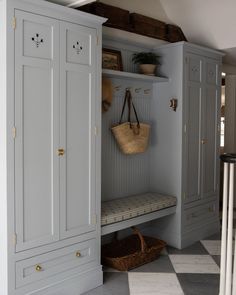 a white and gray cupboard with some baskets on it