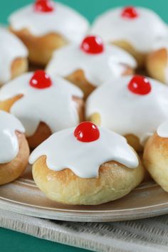 small pastries with cherry toppings on a plate