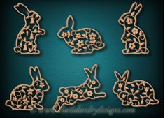 four wooden cutouts of rabbits and flowers