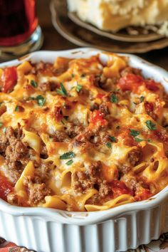 a casserole dish with meat, cheese and sauce in it on a table