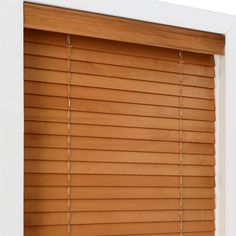 a close up view of a window with wooden blinds on it's side and the bottom part of the blind closed